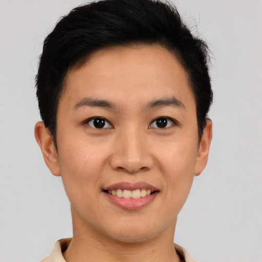 Joyful asian young-adult female with short  brown hair and brown eyes
