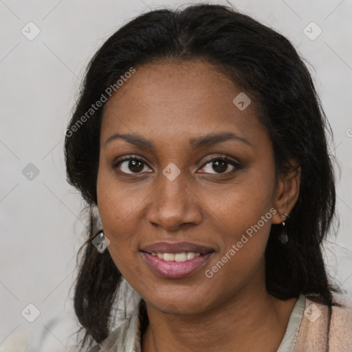 Joyful black young-adult female with long  brown hair and brown eyes