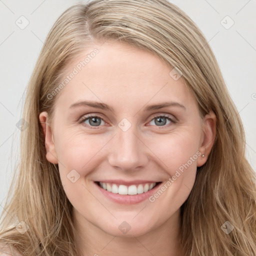 Joyful white young-adult female with long  brown hair and blue eyes