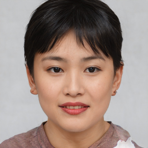 Joyful asian child female with short  brown hair and brown eyes