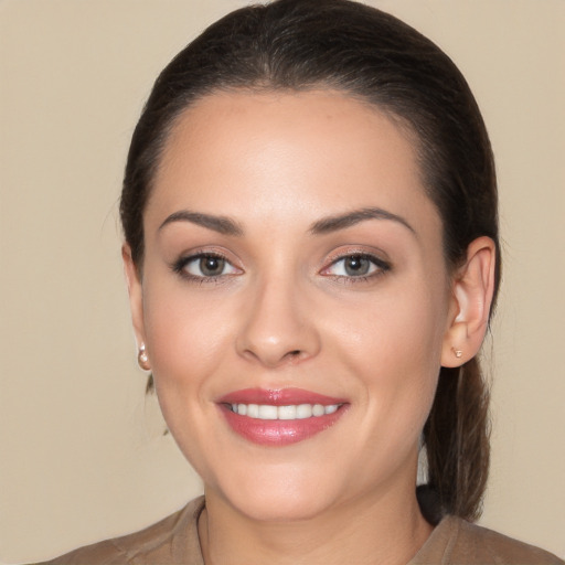 Joyful white young-adult female with long  brown hair and brown eyes