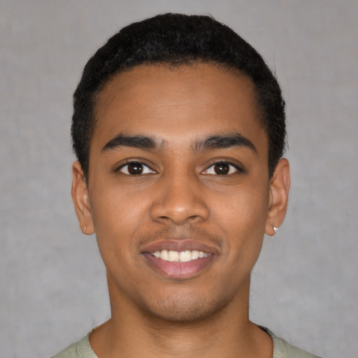 Joyful black young-adult male with short  black hair and brown eyes