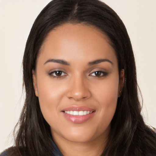 Joyful latino young-adult female with long  brown hair and brown eyes