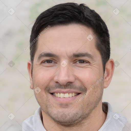 Joyful white young-adult male with short  black hair and brown eyes