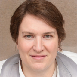 Joyful white adult female with medium  brown hair and grey eyes