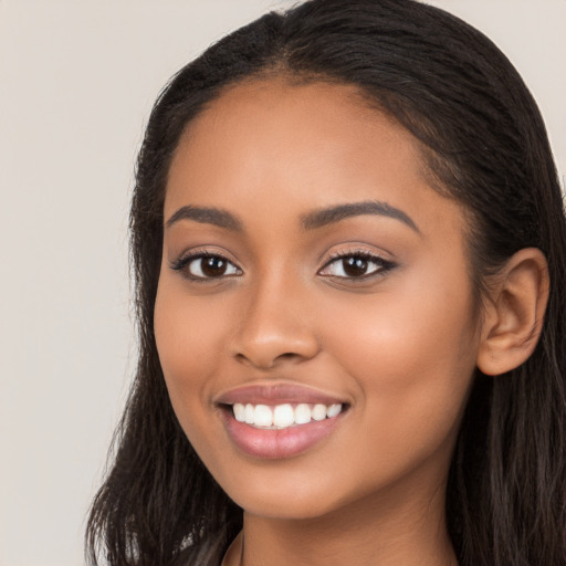 Joyful latino young-adult female with long  brown hair and brown eyes