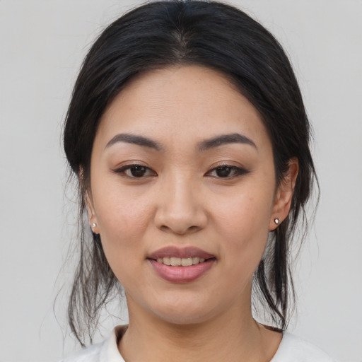 Joyful asian young-adult female with medium  black hair and brown eyes