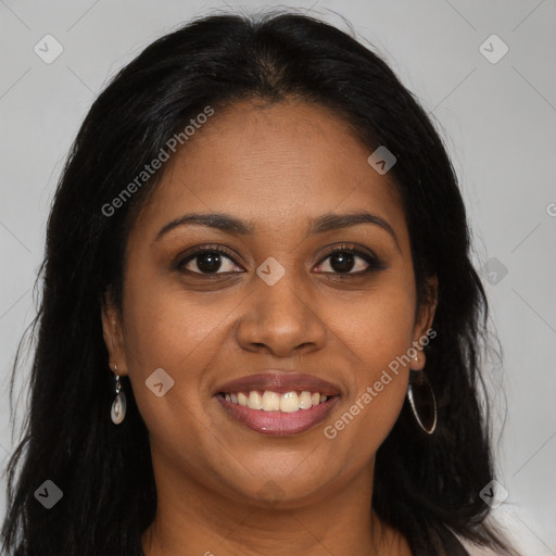 Joyful black young-adult female with long  brown hair and brown eyes