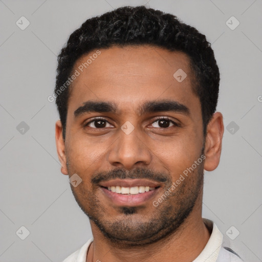 Joyful black young-adult male with short  black hair and brown eyes