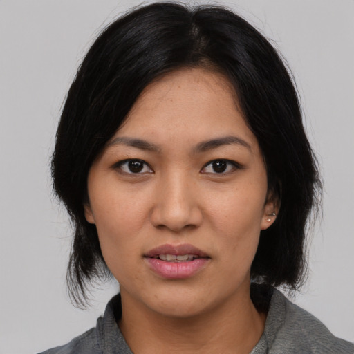 Joyful asian young-adult female with medium  black hair and brown eyes