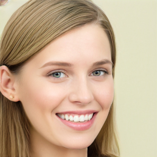 Joyful white young-adult female with long  brown hair and blue eyes