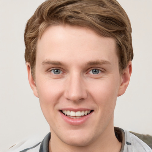 Joyful white young-adult male with short  brown hair and grey eyes