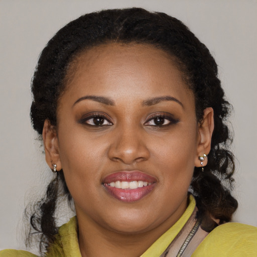 Joyful black young-adult female with medium  brown hair and brown eyes