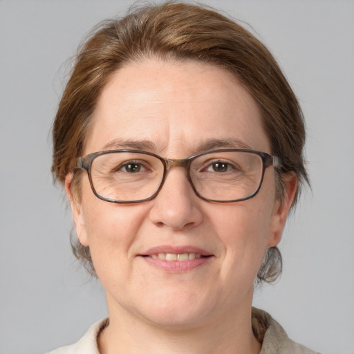 Joyful white adult female with medium  brown hair and blue eyes