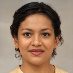 Joyful latino young-adult female with medium  brown hair and brown eyes