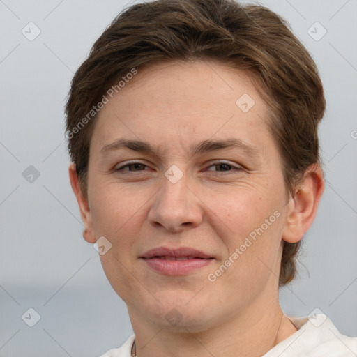 Joyful white adult female with short  brown hair and grey eyes