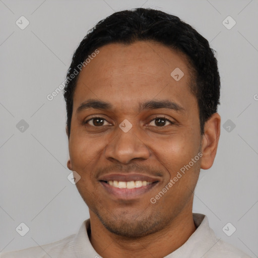 Joyful latino young-adult male with short  black hair and brown eyes