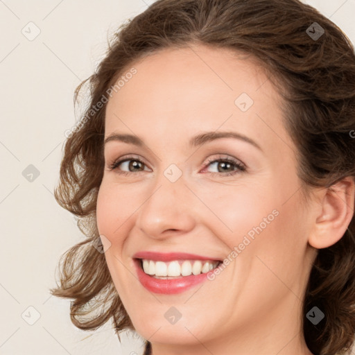 Joyful white young-adult female with medium  brown hair and green eyes