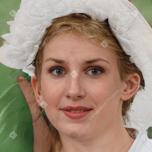 Joyful white young-adult female with medium  brown hair and blue eyes