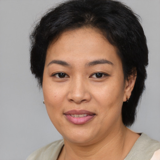 Joyful asian adult female with short  brown hair and brown eyes