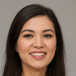 Joyful white young-adult female with long  brown hair and brown eyes