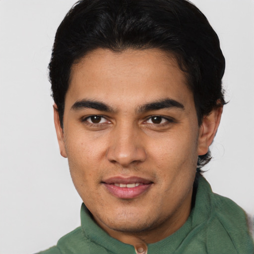 Joyful latino young-adult male with short  black hair and brown eyes