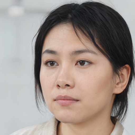 Neutral asian young-adult female with medium  brown hair and brown eyes