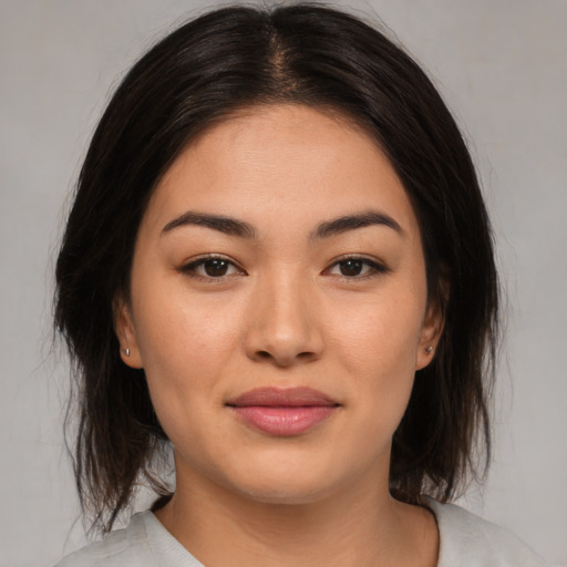 Joyful asian young-adult female with medium  brown hair and brown eyes