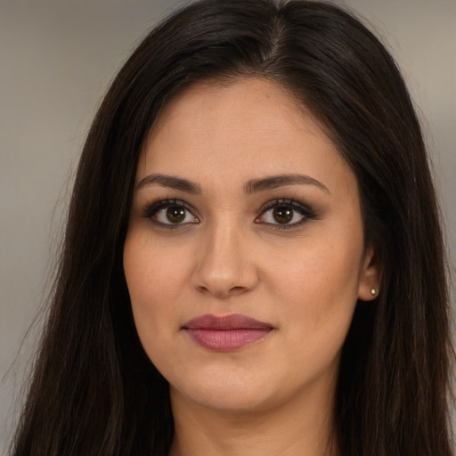 Joyful white young-adult female with long  brown hair and brown eyes