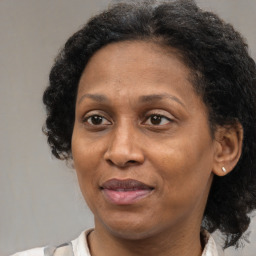 Joyful latino adult female with medium  brown hair and brown eyes