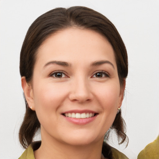 Joyful white young-adult female with medium  brown hair and brown eyes