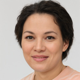 Joyful white adult female with short  brown hair and brown eyes