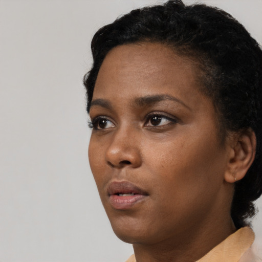 Neutral black young-adult female with short  black hair and brown eyes