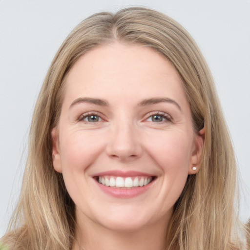 Joyful white young-adult female with long  brown hair and grey eyes