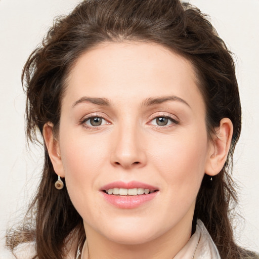 Joyful white young-adult female with long  brown hair and green eyes