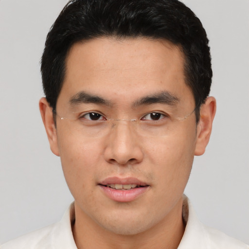 Joyful asian young-adult male with short  brown hair and brown eyes