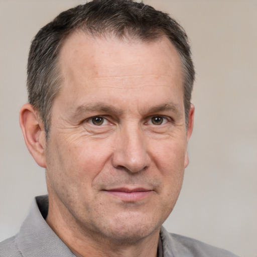 Joyful white middle-aged male with short  brown hair and brown eyes