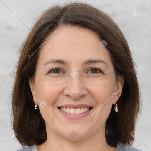 Joyful white adult female with medium  brown hair and grey eyes