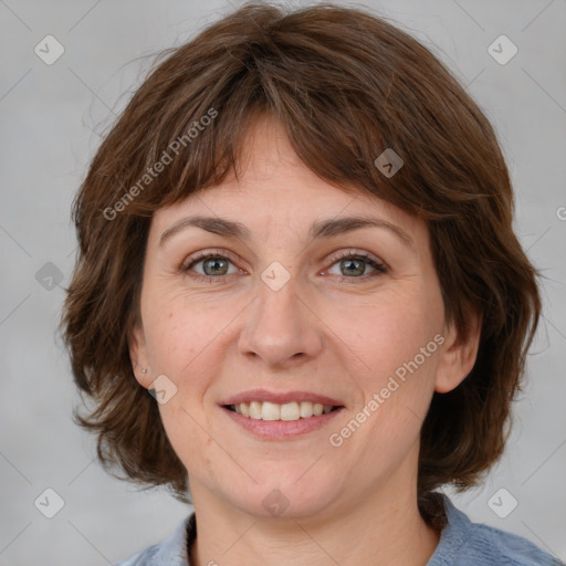 Joyful white adult female with medium  brown hair and blue eyes