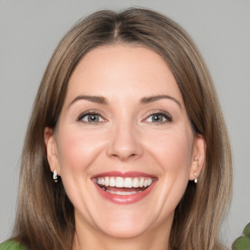 Joyful white young-adult female with medium  brown hair and green eyes