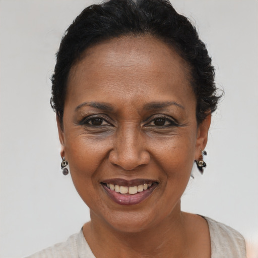 Joyful black adult female with short  brown hair and brown eyes