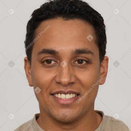 Joyful black adult male with short  black hair and brown eyes