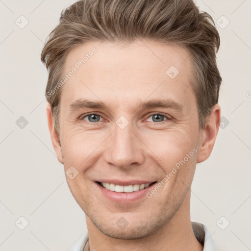 Joyful white young-adult male with short  brown hair and grey eyes