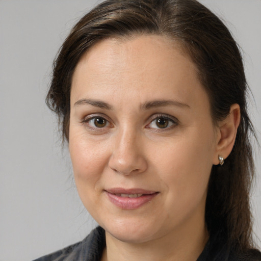 Joyful white adult female with medium  brown hair and brown eyes