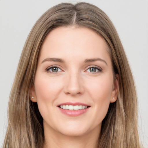 Joyful white young-adult female with long  brown hair and grey eyes