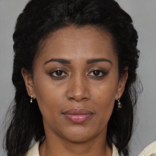 Joyful black young-adult female with medium  brown hair and brown eyes