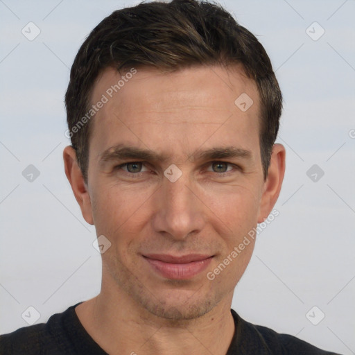 Joyful white adult male with short  brown hair and grey eyes