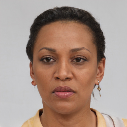 Joyful latino adult female with short  brown hair and brown eyes