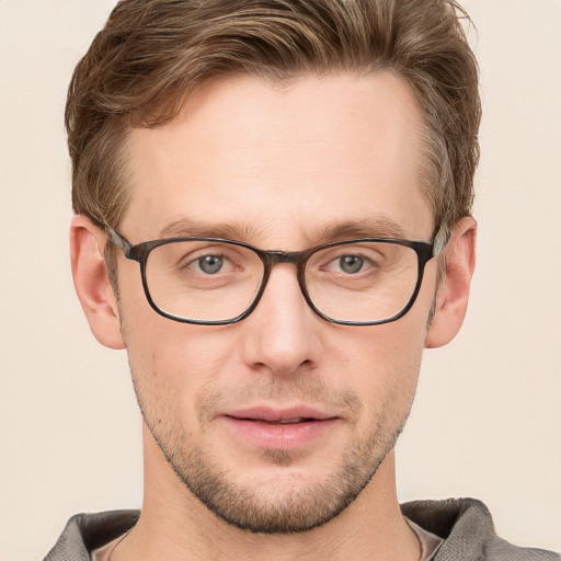 Joyful white young-adult male with short  brown hair and grey eyes