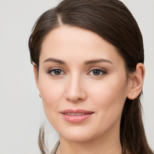 Joyful white young-adult female with long  brown hair and grey eyes